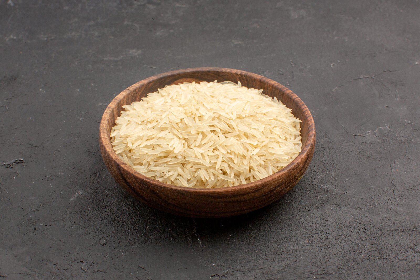 front-view-raw-rice-inside-brown-plate-grey-space